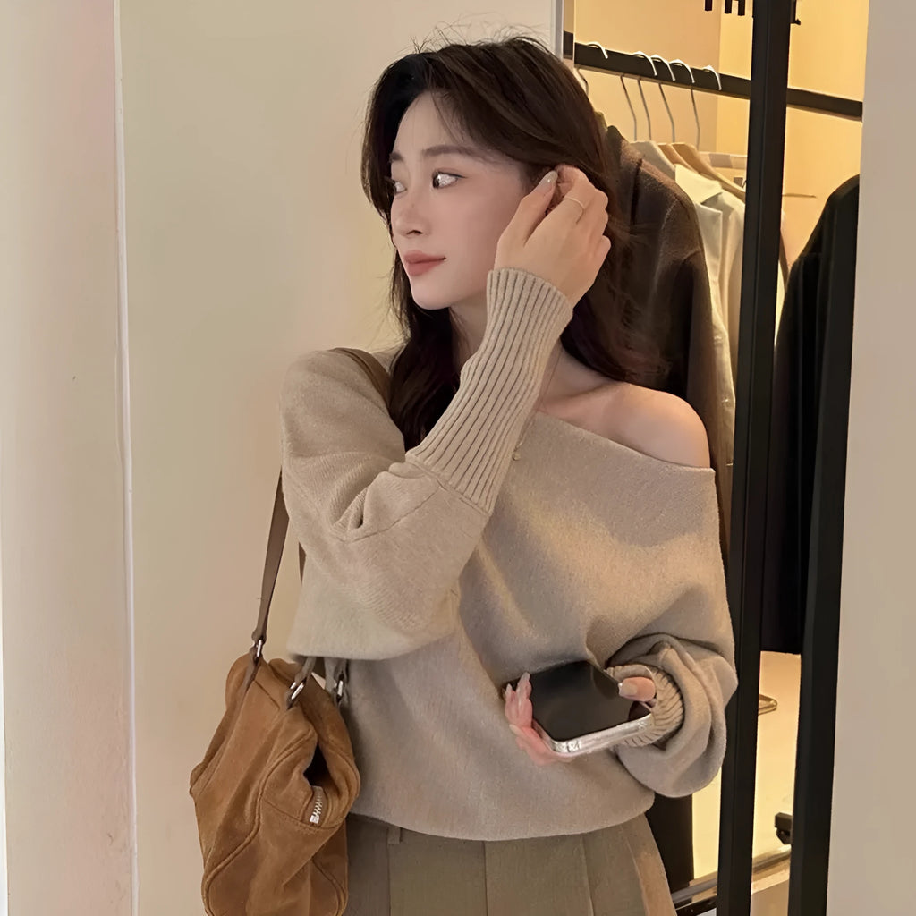 Women's long sleeve viscose pullover blouse in carbon grey, shown on a hanger.