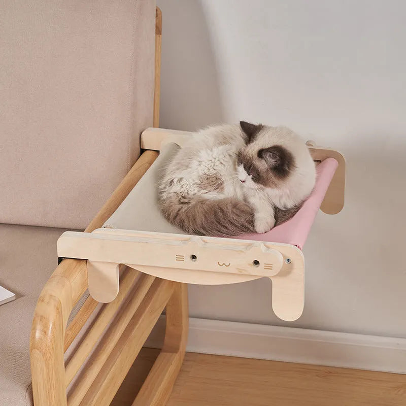 Solid wood cat bed with a removable fabric cover in a grey pink colour.