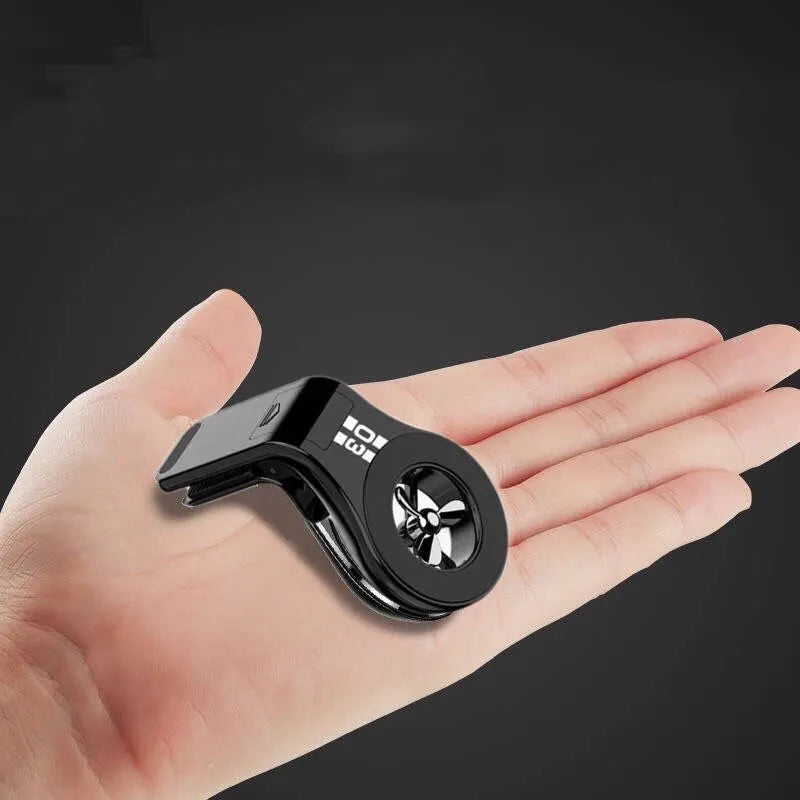 Black magnetic car phone holder mounted on a car air vent, showing 360-degree rotation and fragrance slot.