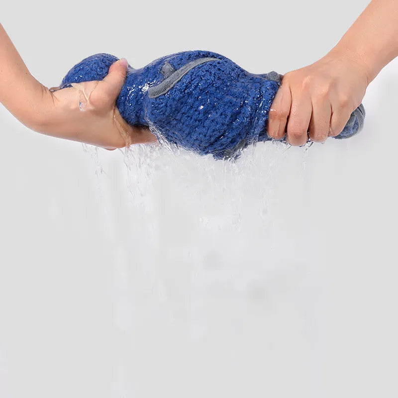 A blue dog bath robe towel with an adjustable waistband wrapped around a dog, showing the snap button closure.