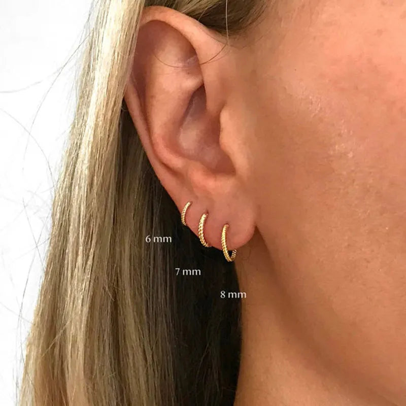 Sterling silver twisted string round hoop earrings in gold colour, showing geometric detail.