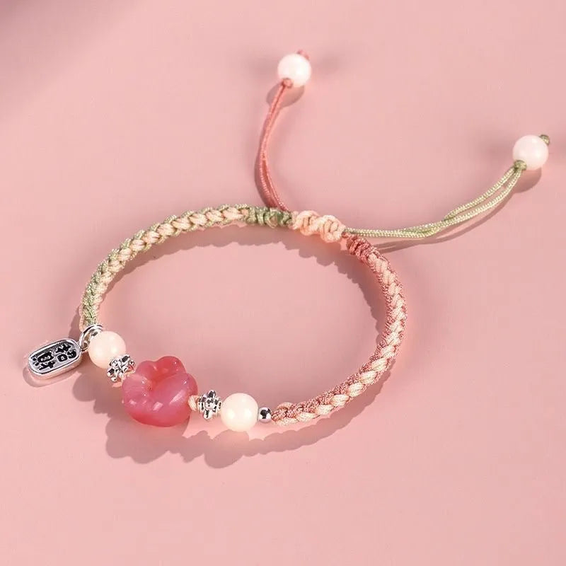 Handmade glass cat paw couple bracelet with red charm on pink or yellow woven cord