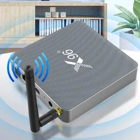 Android Smart TV set-top box with voice remote, HDMI cable, and power adapter on a table.
