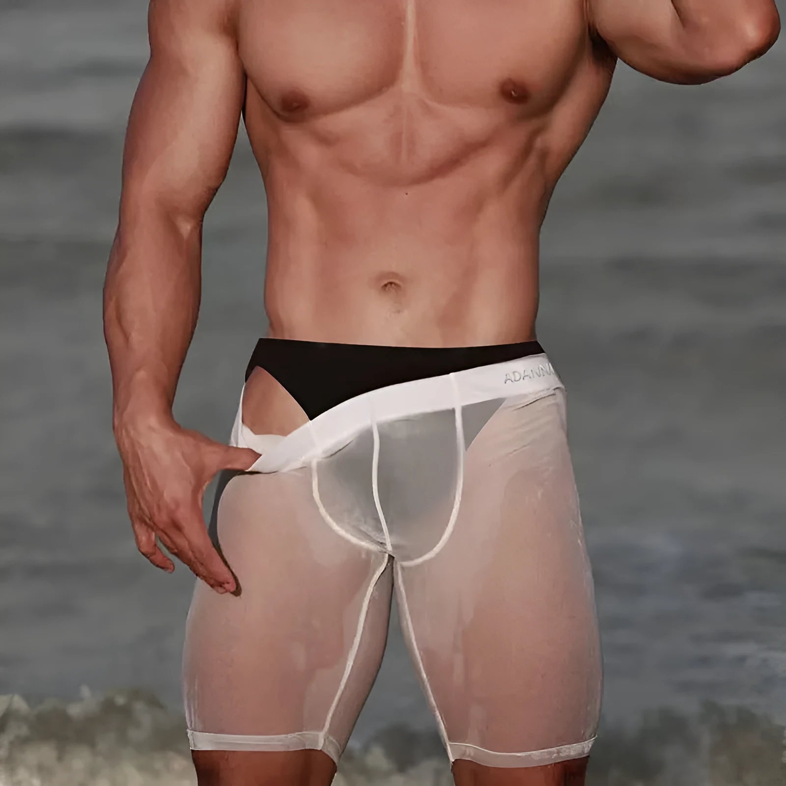 Men's solid colour mesh home shorts in knitted nylon fabric on a neutral background