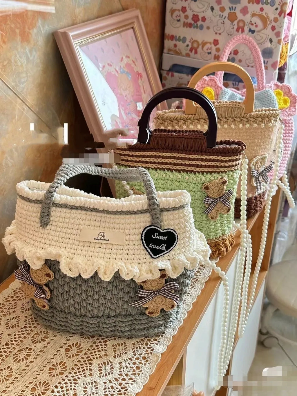 Wool crocheted bear shoulder bag with wooden handle showing crochet texture and random colour design