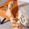 Gold PVC lace-up high-heeled sandals with square toe and profiled heel on display