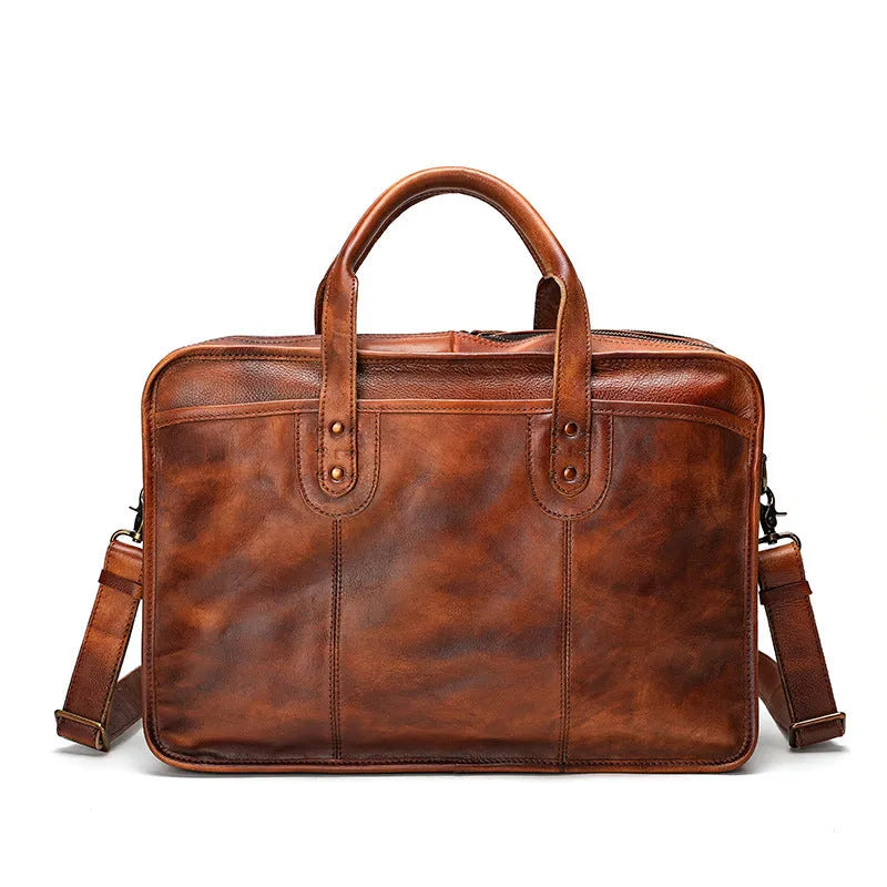 Brown vintage leather men's briefcase showing internal organiser pockets and laptop sleeve.