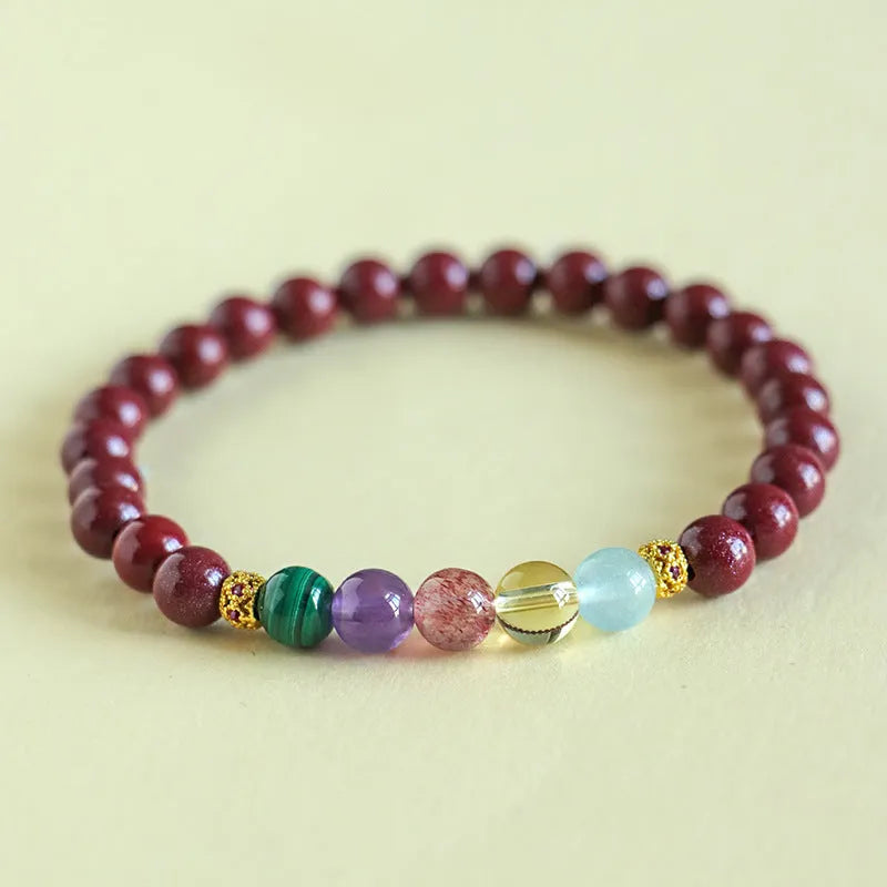 Purple gold cinnabar crystal bead bracelet with adjustable knot on wrist