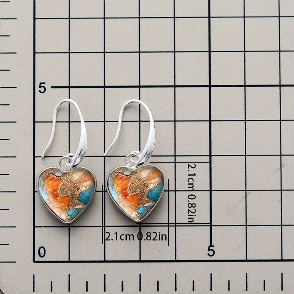 Silver alloy vintage bohemian water droplet pendant drop earrings on light background