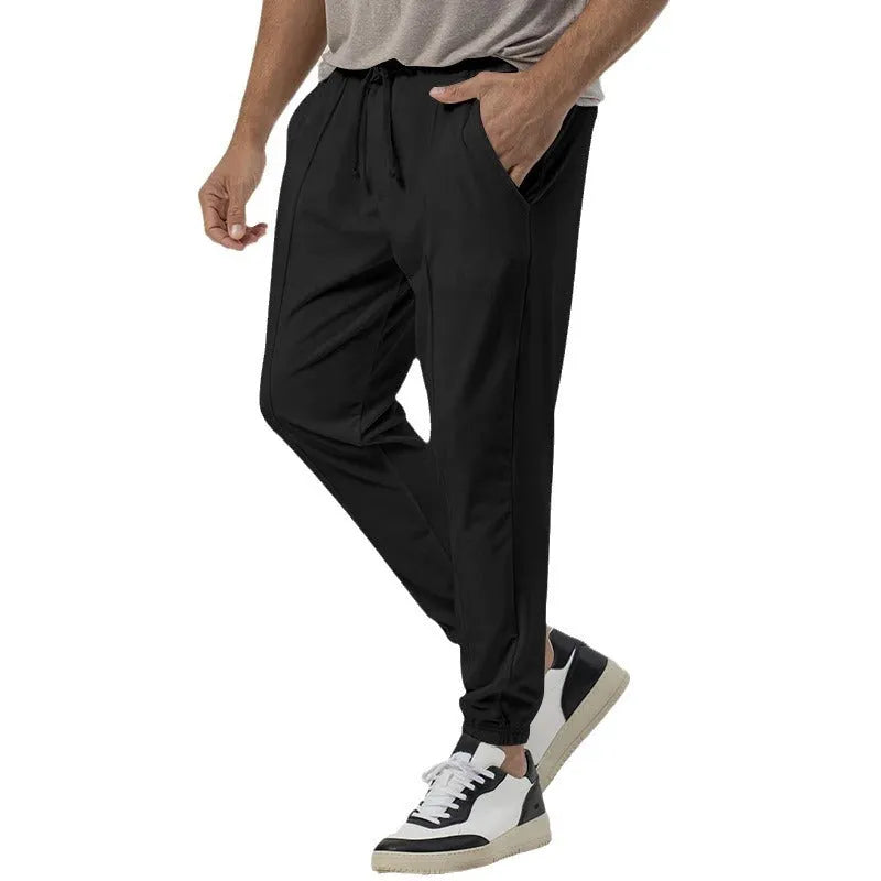Men's grey straight-leg casual track sweatpants with elasticated waist on a neutral background.