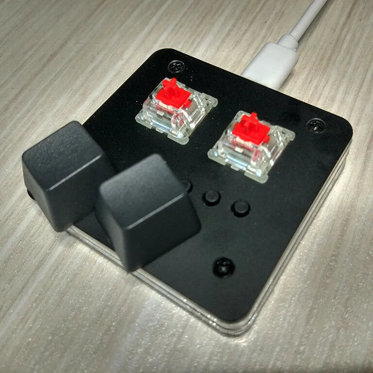Compact white USB keyboard with a touch panel and multimedia function keys on a desk.