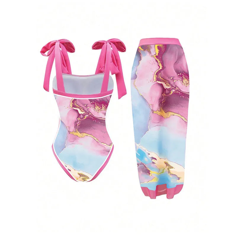 Pink printed women's one-piece swimsuit with a sheath silhouette and attached skirt.