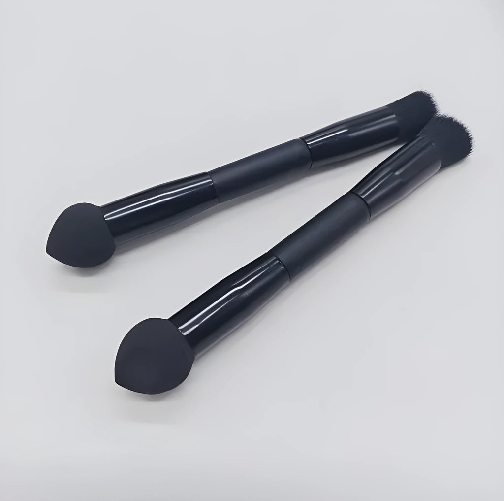 Black double-headed concealer brush with sponge end and tapered brush end on wooden handle