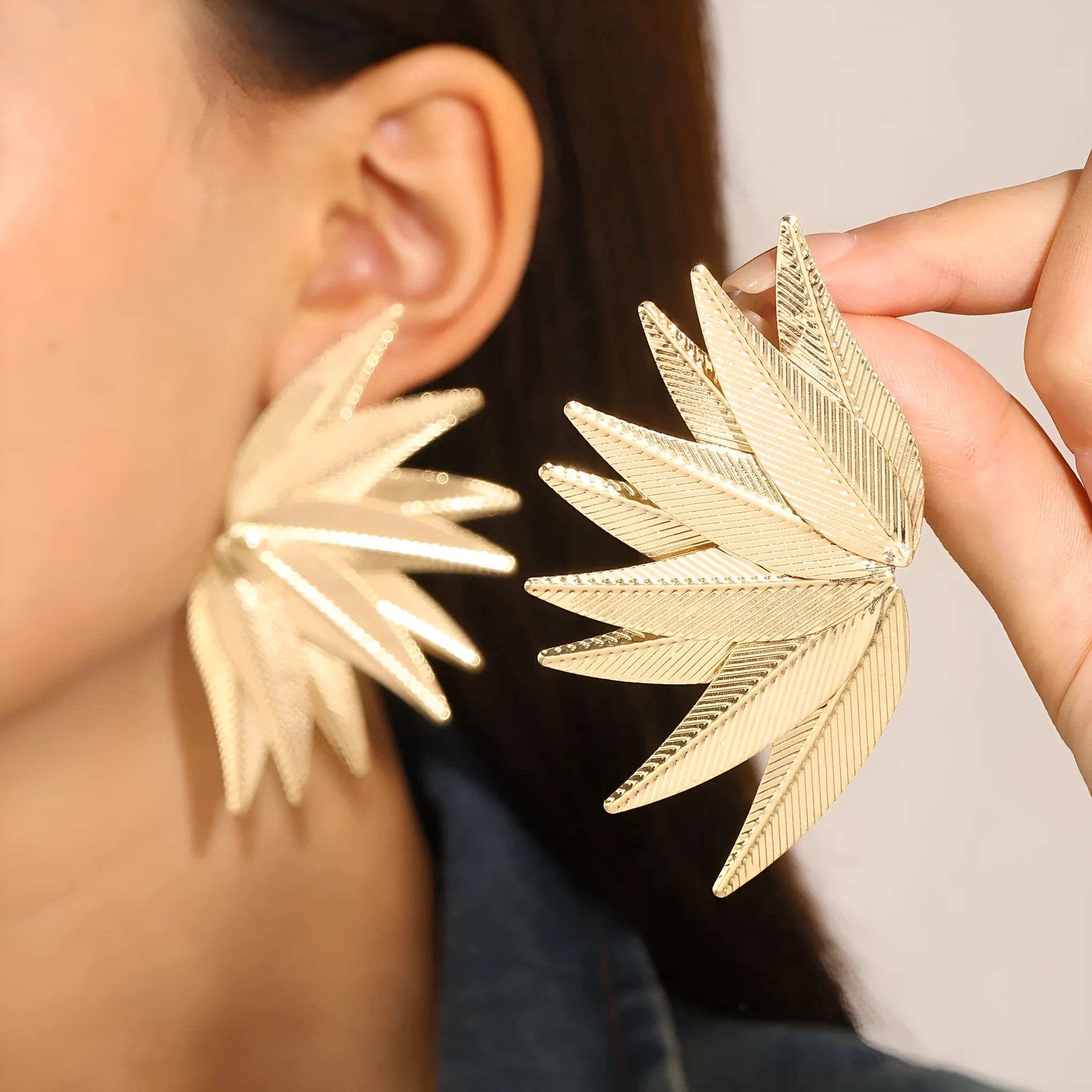 Alloy metal leaf silhouette earrings in white and gold colour options showing botanical jewellery design