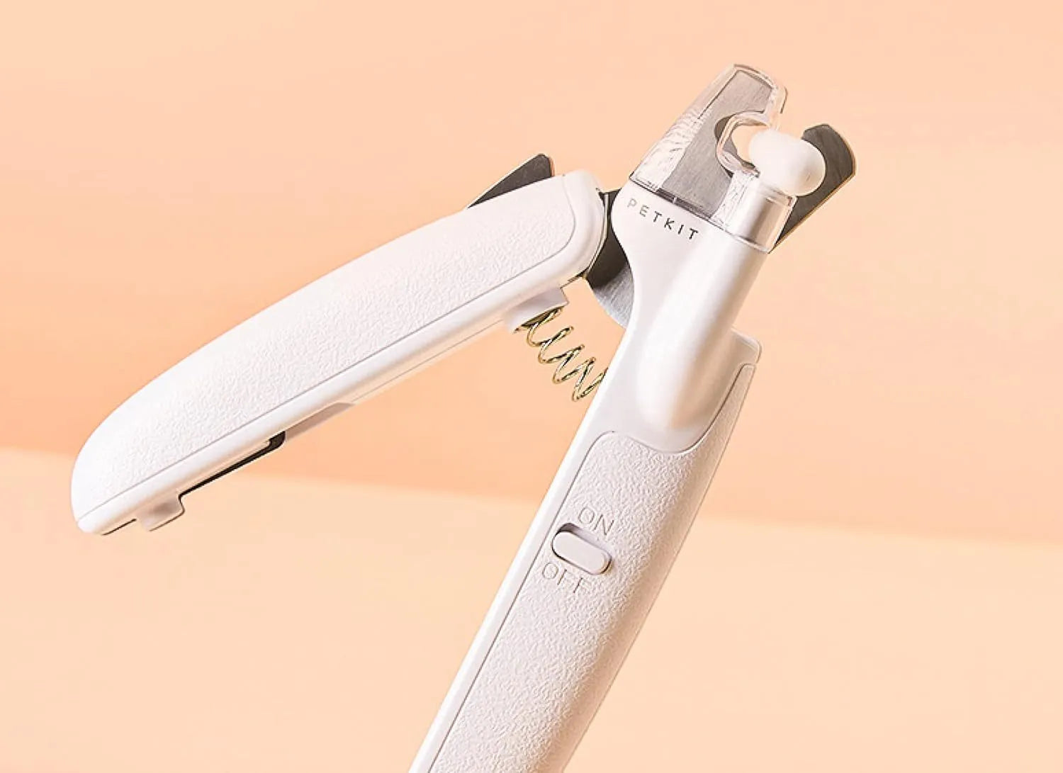 White pet nail clippers with LED light, transparent anti-splash guard, and triangular blade for cats and dogs