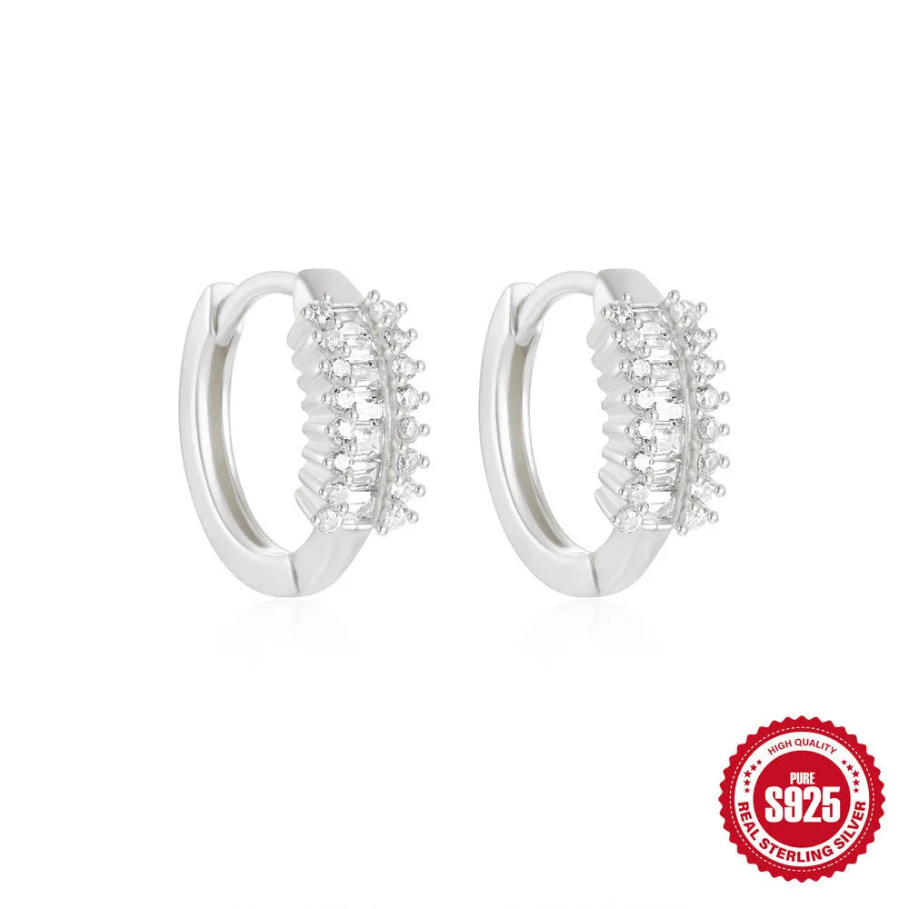 Small round sterling silver geometric stud earrings with a circle design in a gold or silver finish.
