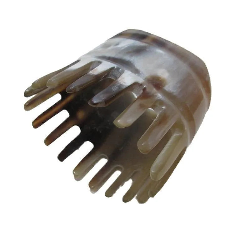 Black buffalo horn comb with wide teeth and a pointed long tip for hair and scalp massage.