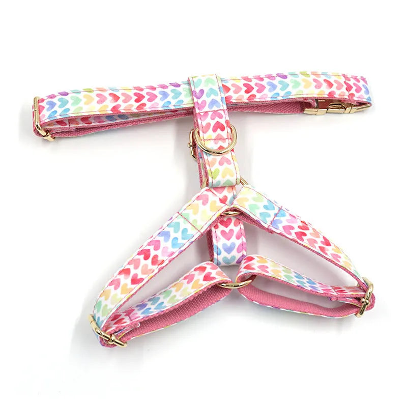 Pink dog harness with gold buckle and colourful heart-shaped stone decoration in four sizes