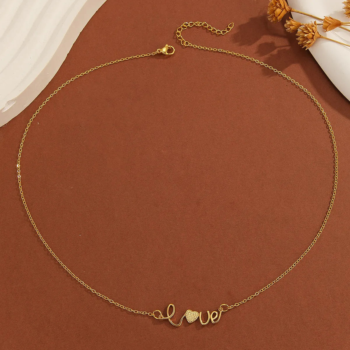 Gold plated copper infinity love pendant necklace with diamond accents and fine chain.