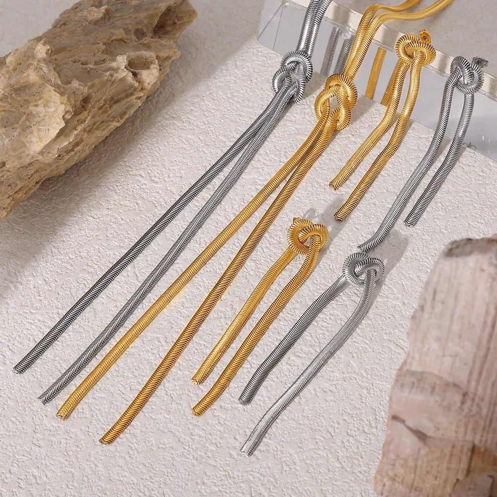 Women's gold knotted tassel necklace on snake chain with matching titanium steel earrings