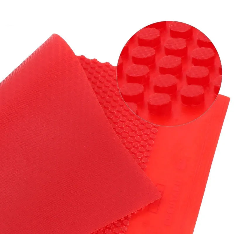 Single sheet of black raw table tennis rubber with a small particle textured surface.