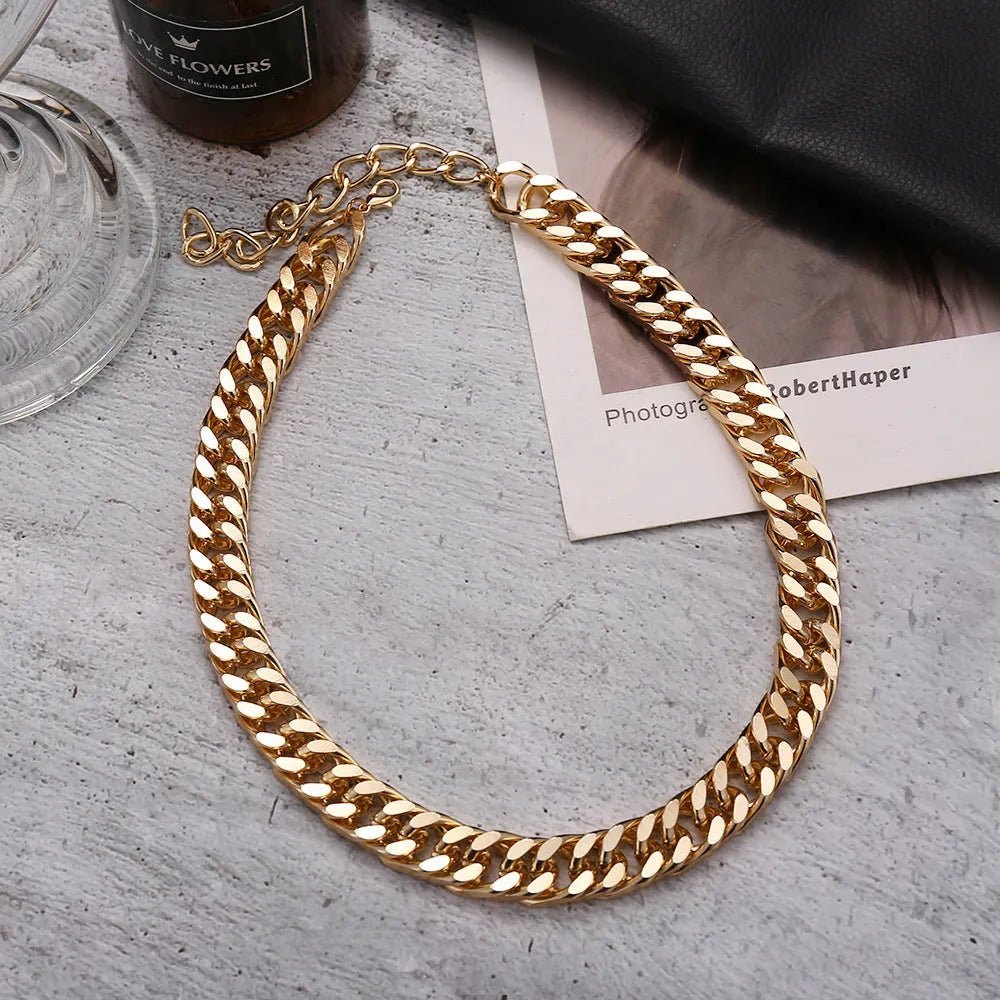 Gold tone women's necklace with thick 6cm chain links on a 32cm alloy chain, electroplated finish.