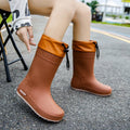 Women's solid colour rain boots with non-slip soles and waterproof mouth design in apricot, black, brown, or pink