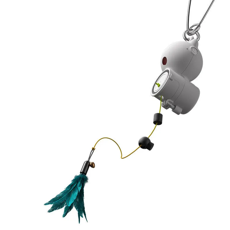 White plastic hanging retractable cat toy with feather lure and USB cable on hook