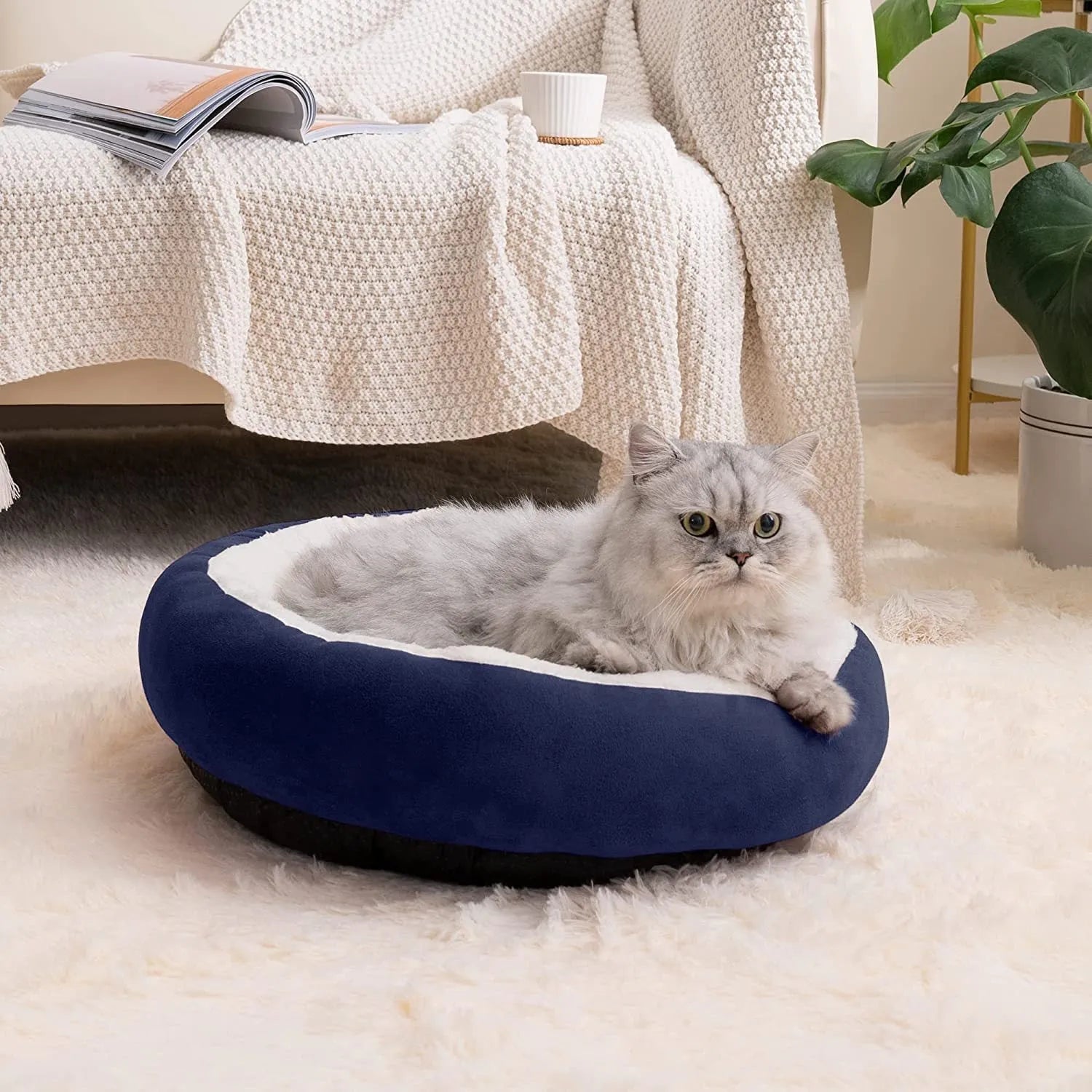 Circular grey cloth pet bed with raised sides for a cat or small dog