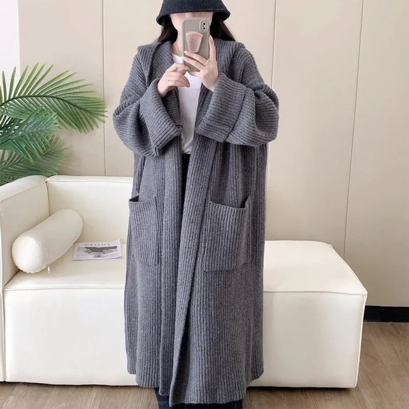Loose grey hooded cardigan coat for women with raglan sleeves on a hanger