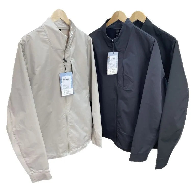 Man wearing a milky white stand collar casual jacket with long sleeves and a straight hem.