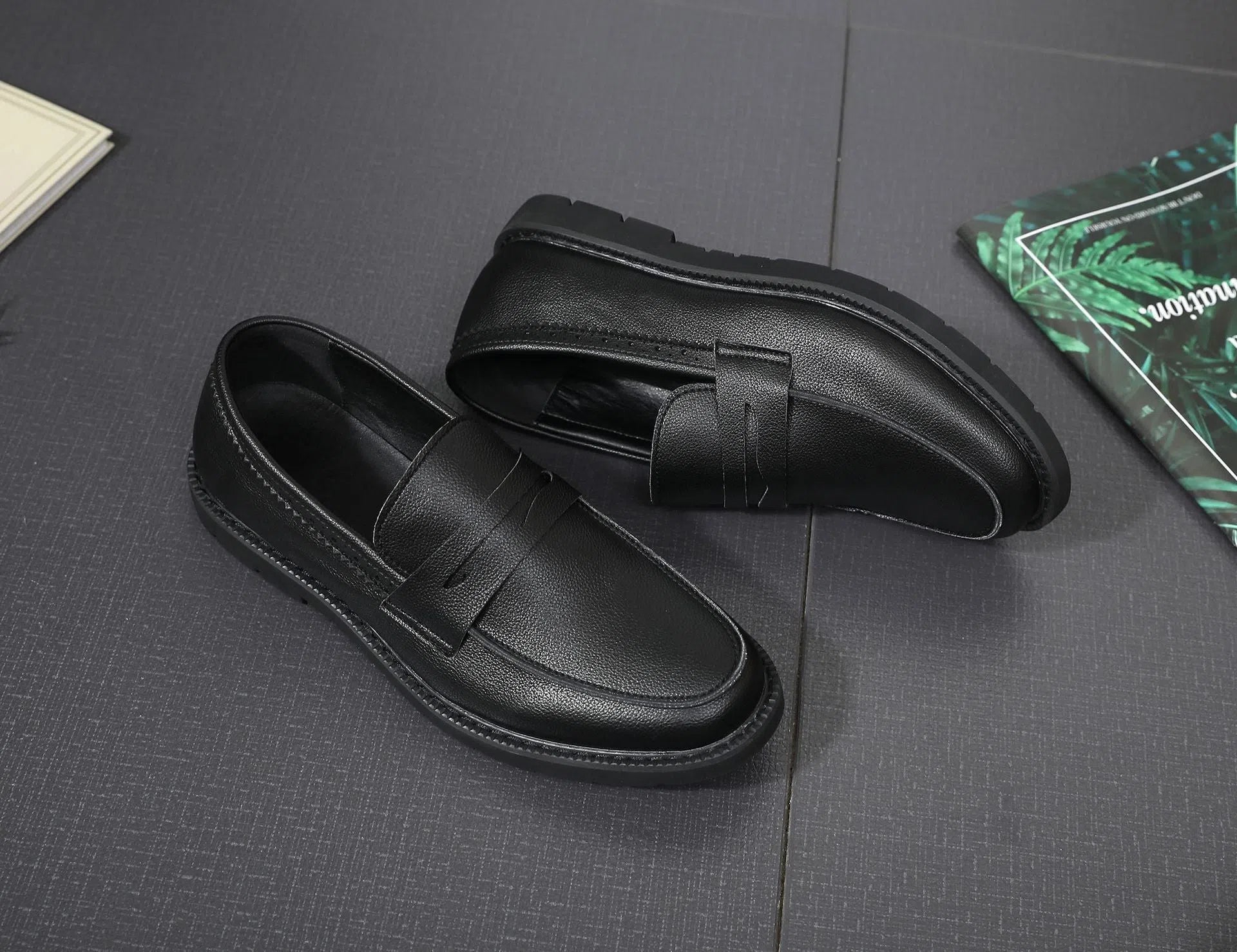 Men's black Korean retro slip-on driving shoes with microfiber upper and stitched detailing on white background