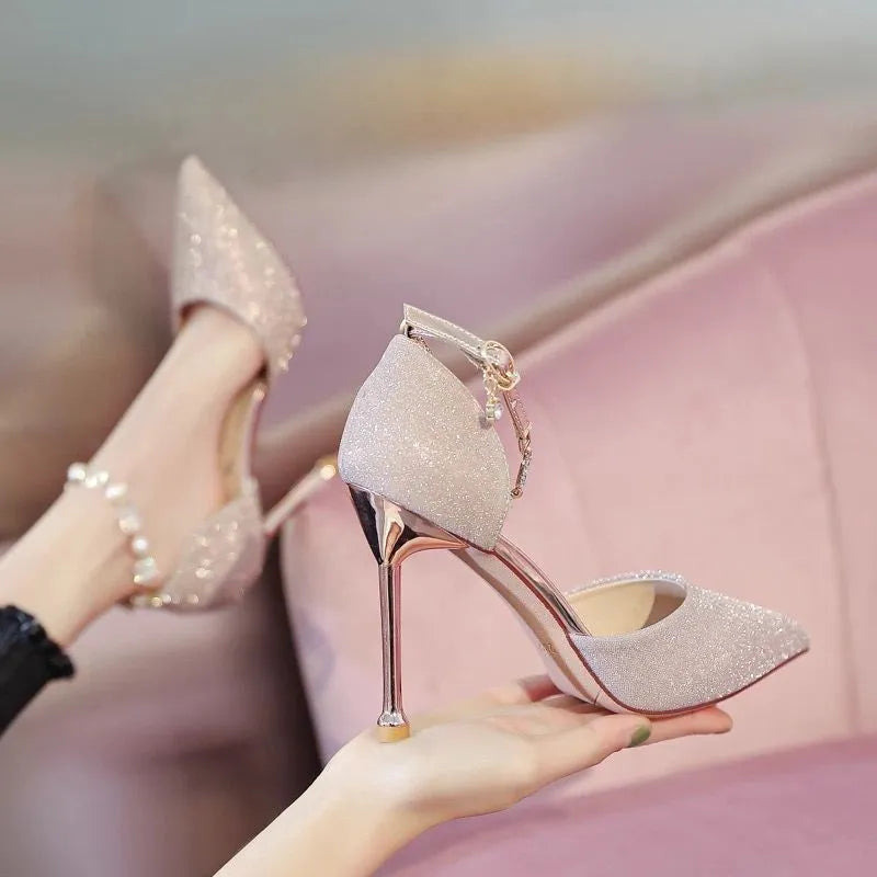 French high heel wedding shoes in silver with pointed toe, stiletto heel, and buckle closure on a clean background