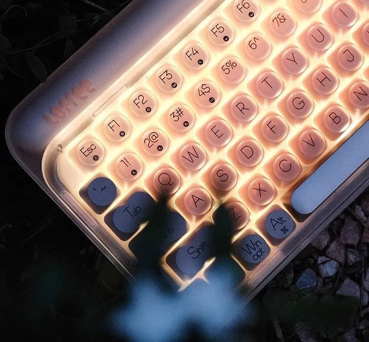 Liquid foundation colour wireless mechanical keyboard bundle with mouse, lamp, and calculator on a desk.
