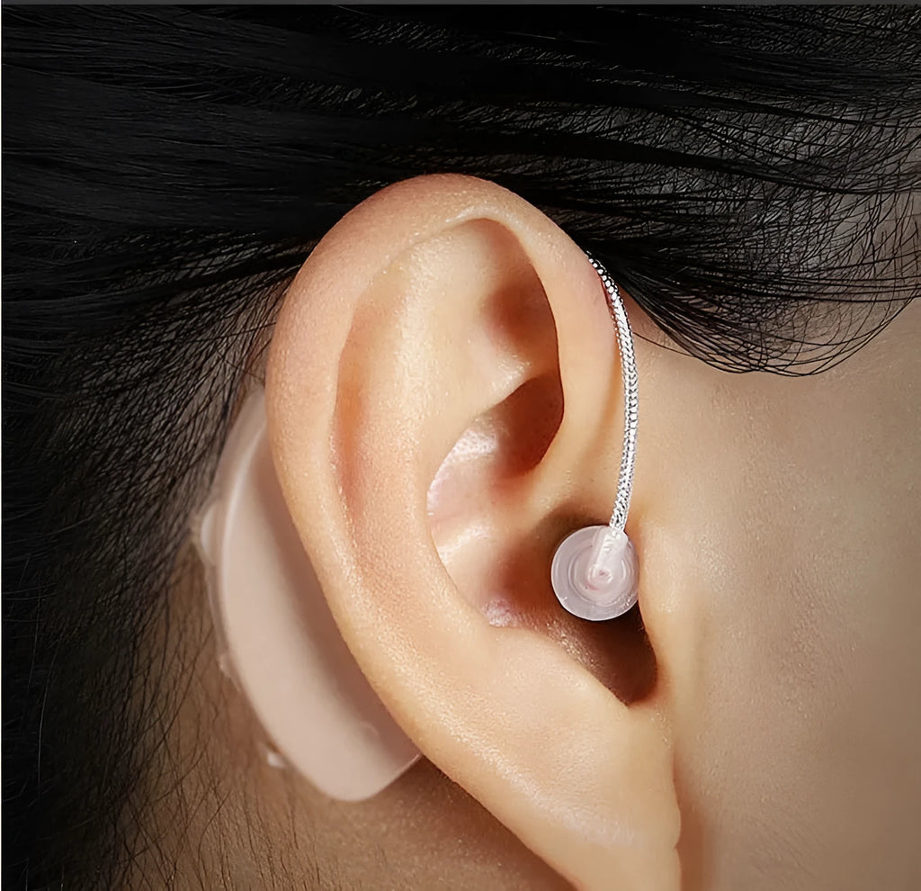 Black rechargeable hearing aid amplifier with silicone ear tips for elderly users