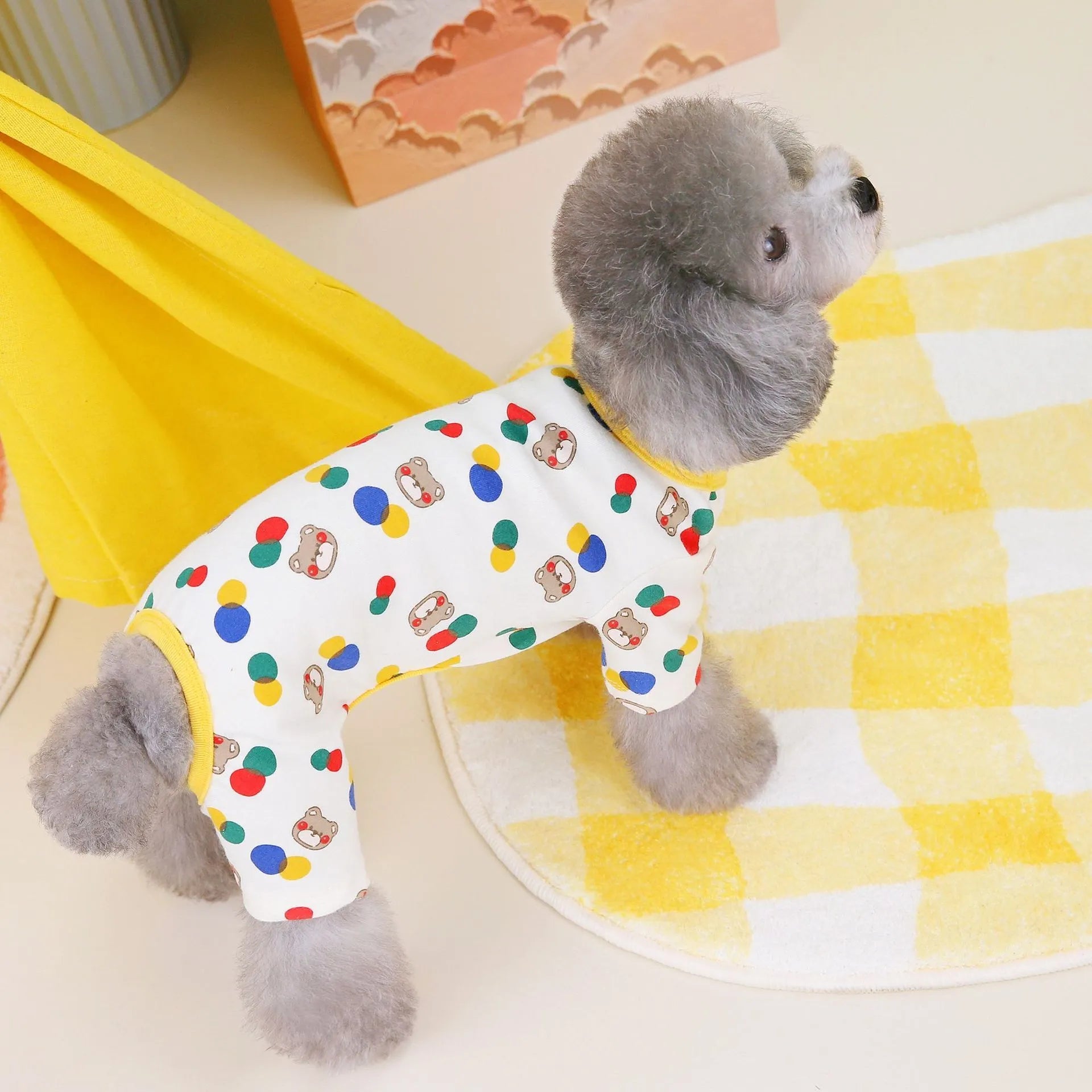 Beige dog t-shirt with a colourful cartoon bear print, showing a casual fit on a pet.