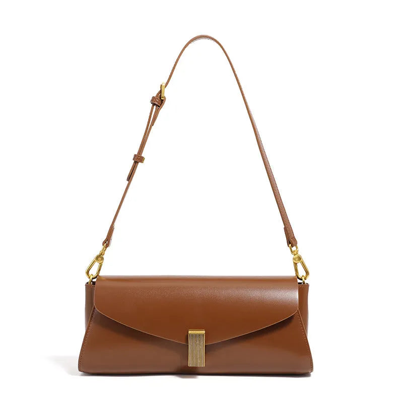 Women's leather cross-body shoulder bag in clamshell design with internal organisers.