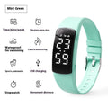 Smart vibration alarm watch with LED display and coloured silicone strap on a wrist
