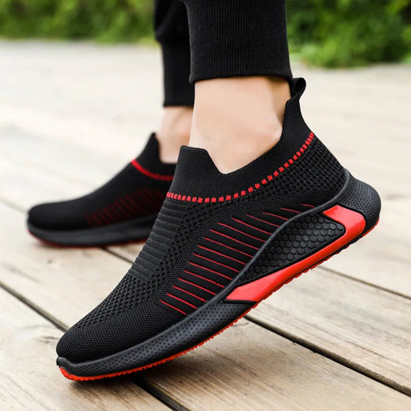 Men's low-cut sneakers with striped Flyknit upper, mesh lining, and flat plastic sole.