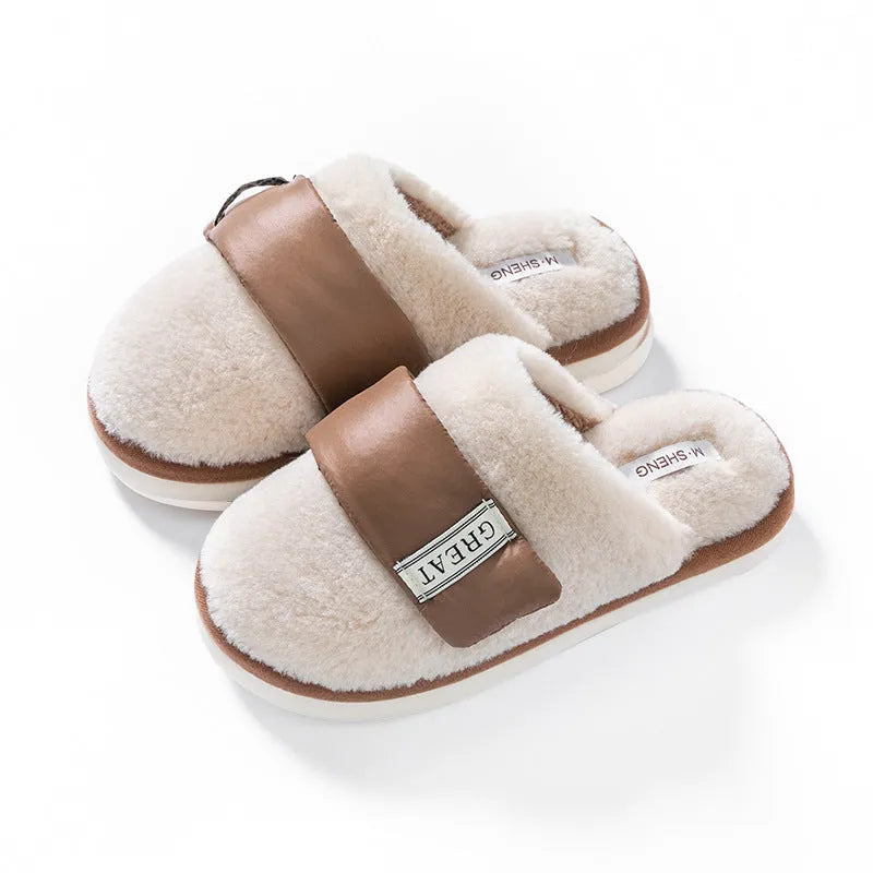 Beige women's plush slippers with a Velcro strap and non-slip plastic sole on a wooden floor.