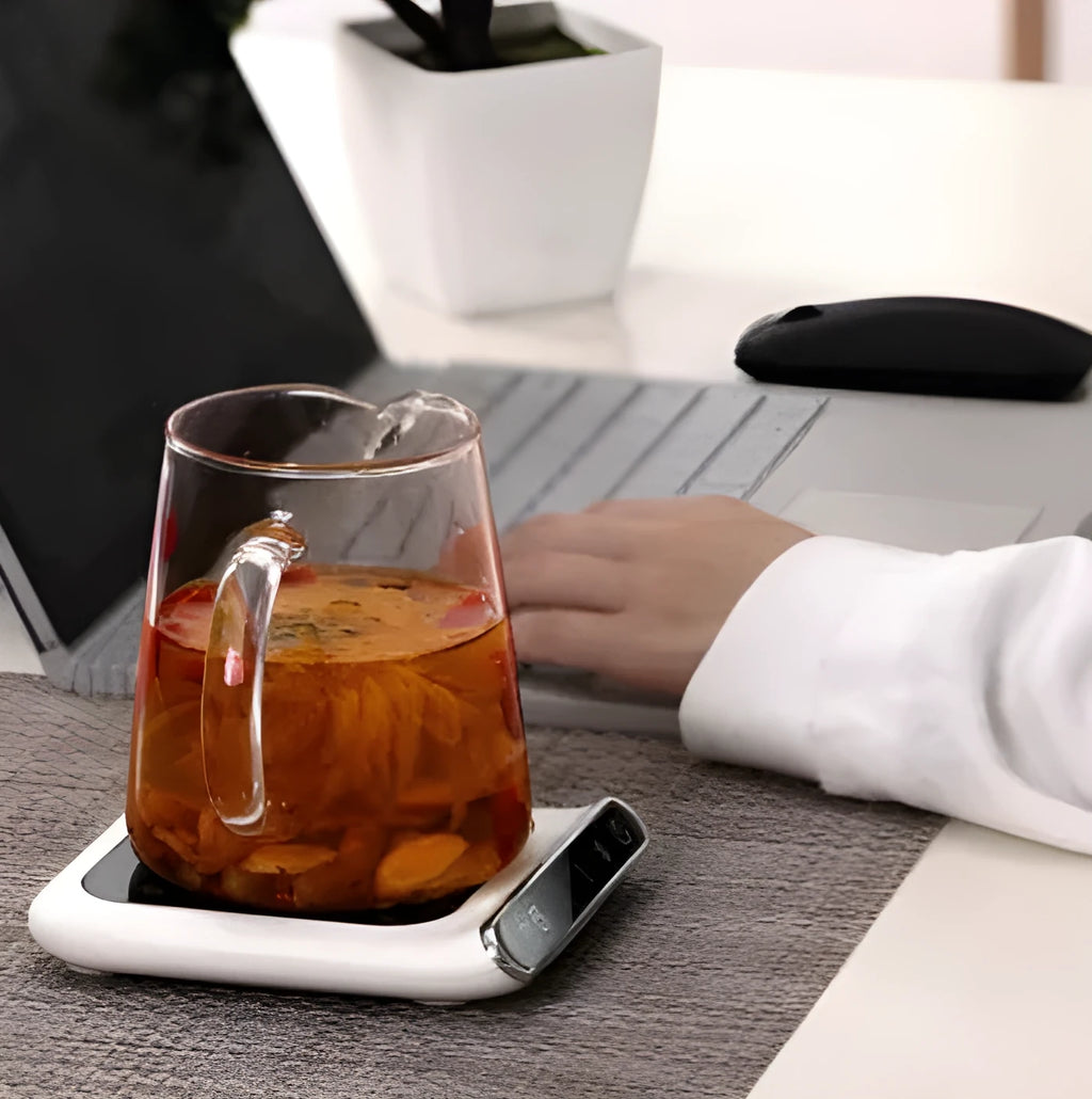 Black mini USB cup warmer with heating coaster on a desk