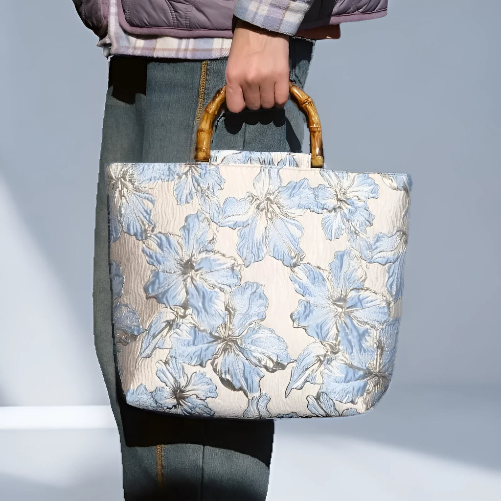 Light blue women's canvas bag with gold bronzing flower pattern showing double shoulder straps and square shape