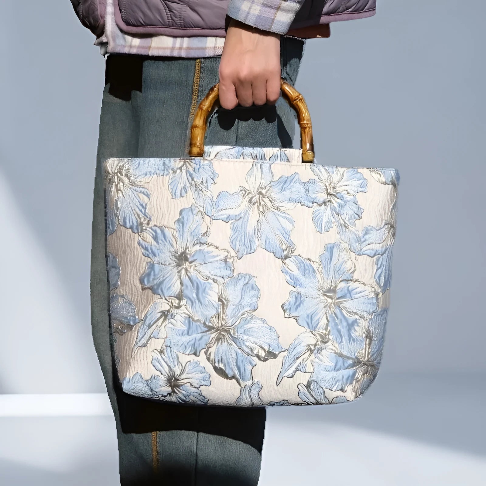 Light blue women's canvas bag with gold bronzing flower pattern showing double shoulder straps and square shape