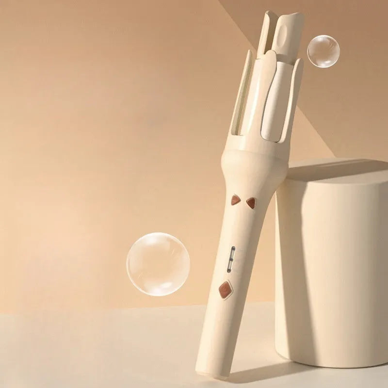 White and pink automatic hair curler with 32mm ceramic barrel and international power plugs on a table.