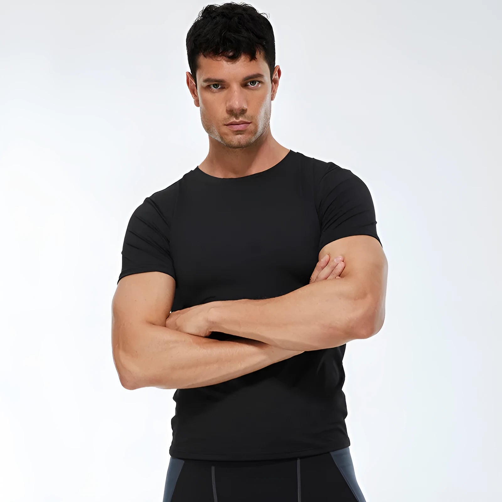 Men's solid colour short-sleeved fitness shirt in quick-drying polyester, shown in multiple colour options.