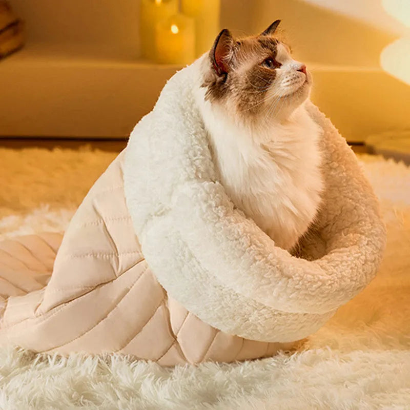 Fleece cat sleeping bag nest in light brown colour with a 3D entrance, shown on a wooden floor.