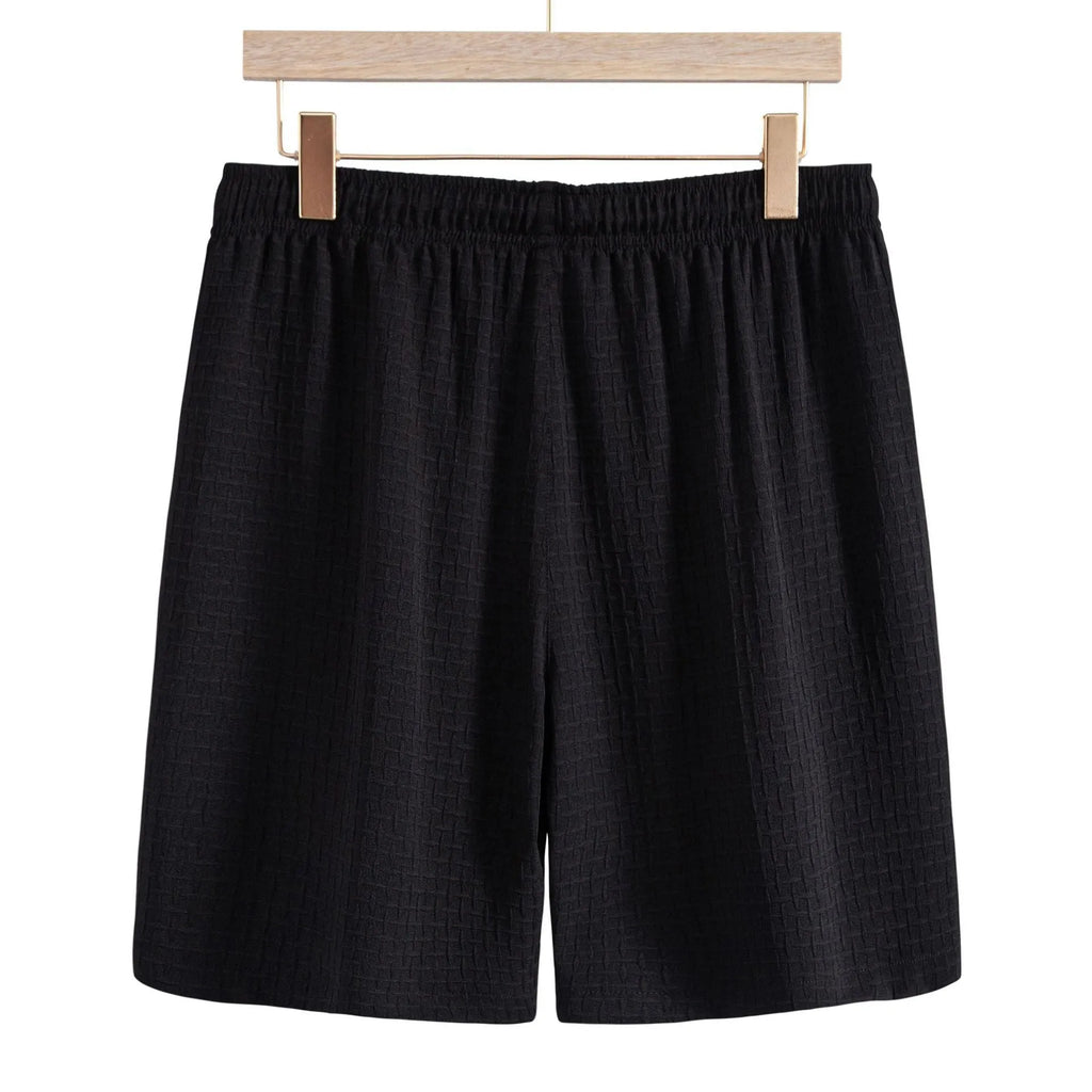 Men's loose fit cotton blend beach shorts suit in black, showing short sleeve shirt and matching shorts.