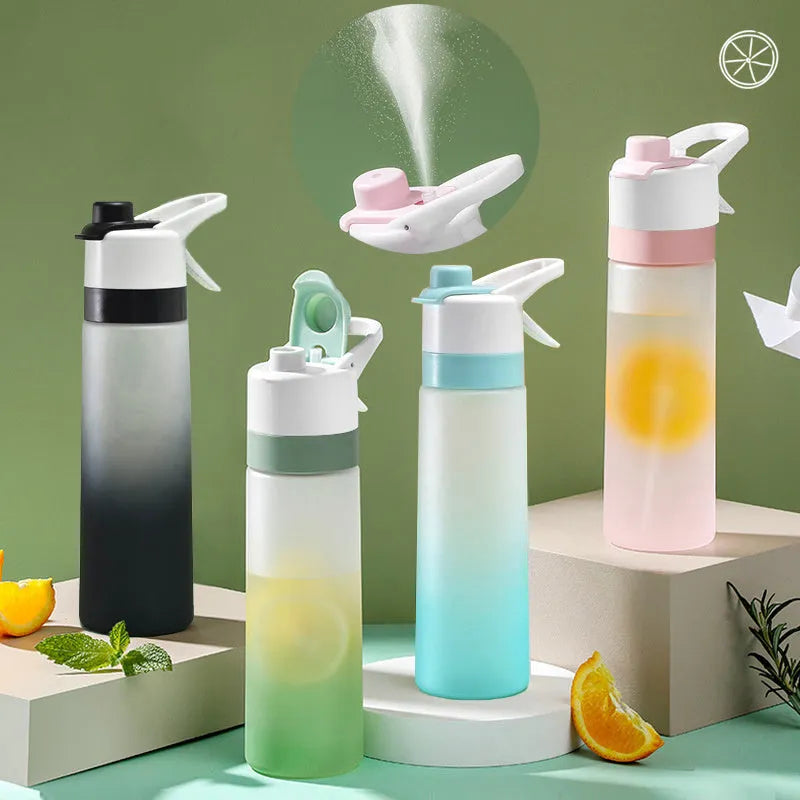 White plastic spray water bottle with handle strap and leakproof lid on a gym bag.
