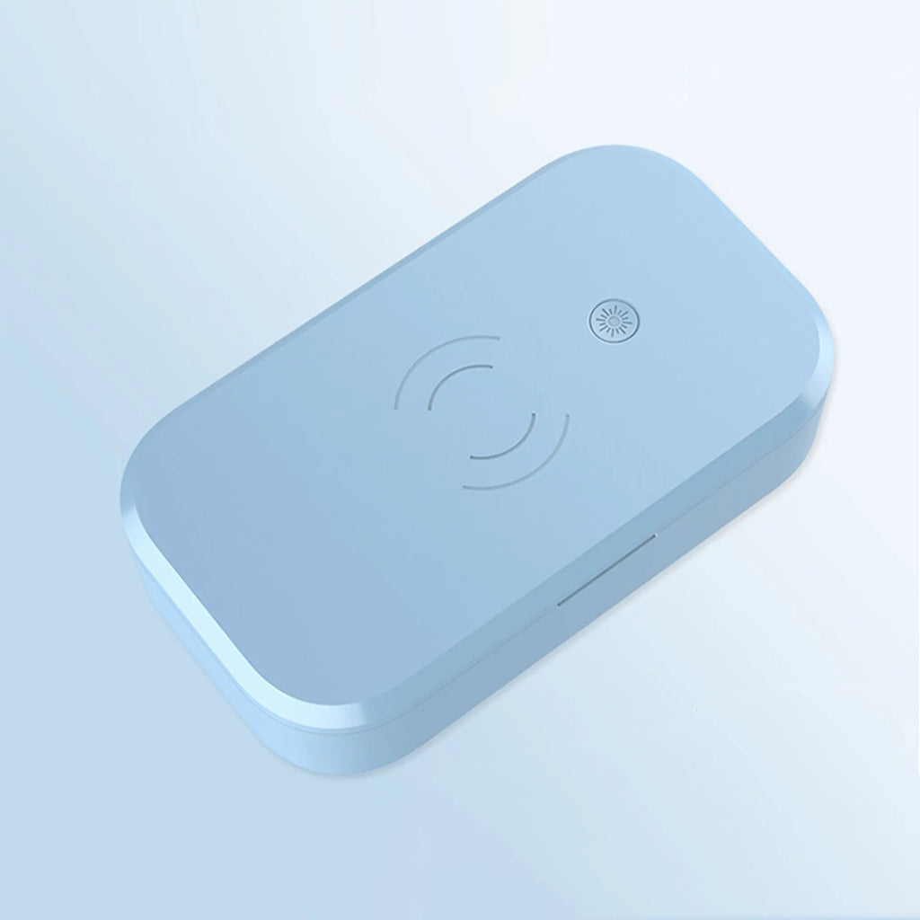 White ultraviolet disinfection box for nail tools with integrated wireless phone charging pad.