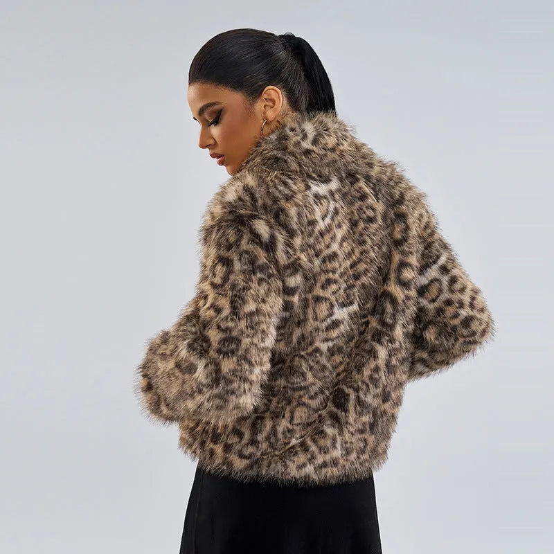 Women's leopard print coat with a buckle lapel closure on a street fashion model.